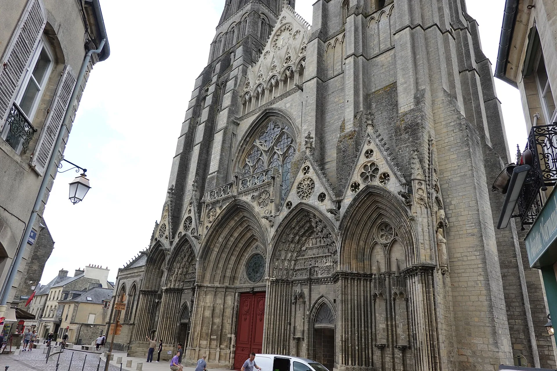 Gothic facade and towers of Bayeux's Notre-Dame Cathedral seen from the street
